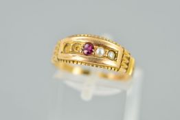 AN EARLY 20TH CENTURY 15CT GOLD RUBY AND SPLIT PEARL RING, the central circular ruby flanked by