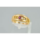 AN EARLY 20TH CENTURY 15CT GOLD RUBY AND SPLIT PEARL RING, the central circular ruby flanked by