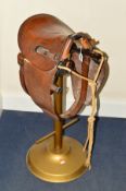 A BESPOKE MADE BAR STOOL, constructed using a Jabezcliff & Co saddle (Walsall 1917) standing on a