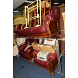 AN OAK FRAMED BURGUNDYLEATHER THREE PIECE SUITE, comprising of a three seater settee and two