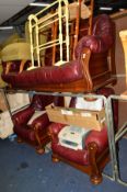 AN OAK FRAMED BURGUNDYLEATHER THREE PIECE SUITE, comprising of a three seater settee and two