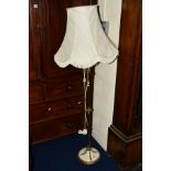 A BRASS AND ONYX STANDARD LAMP with a shade