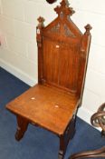 AN EARLY 20TH CENTURY CARVED OAK GOTHIC HALL CHAIR