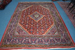 A 20TH CENTURY KUBA STYLE RUG, red and blue ground of a geometric design, 303cm x 207cm