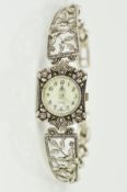 A MODERN SILVER AND MARCASITE LADIES WRISTWATCH, floral panels forming a bangle style, mother of