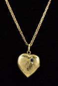 A LATE 20TH CENTURY 9CT GOLD SAPPHIRE SET HEART LOCKET, half engraved measuring approximately 16mm