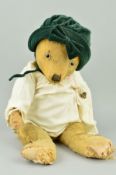 A LARGE WELL LOVED GOLDEN PLUSH TEDDY BEAR, glass eyes, vertical stitched nose, jointed body, mix of
