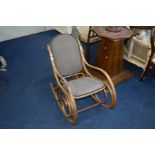 AN OAK FRAMED BENTWOOD ROCKING CHAIR