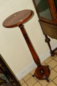 A REPRODUCTION MAHOGANY CIRCULAR TOPPED TORCHERE STAND, raised on a cylindrical upright, circular