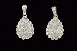 A PAIR OF 9CT WHITE GOLD DROP EARRINGS, each designed as a pear shape with scalloped edging