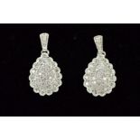 A PAIR OF 9CT WHITE GOLD DROP EARRINGS, each designed as a pear shape with scalloped edging