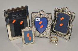 FOUR ELIZABETH II SILVER MOUNTED EASEL BACKED PHOTOGRAPH FRAMES, three in Victorian/Edwardian style,