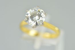 AN 18CT GOLD MOISSANITE SINGLE STONE RING, the circular moissanite within a six claw setting,