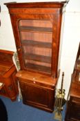 A VICTORIAN FLAME MAHOGANY GLAZED SINGLE DOOR BOOKCASE with a single drawer and panelled cupboard