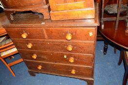 A GEORGIAN OAK CHEST of two short and three long drawers with turned handled on bracket feet,