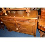 AN OAK SIDEBOARD with two drawers