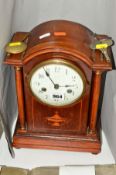 A MAHOGANY MANTLE CLOCK, the dome topped pediment on two pillars, the body inlaid with twin