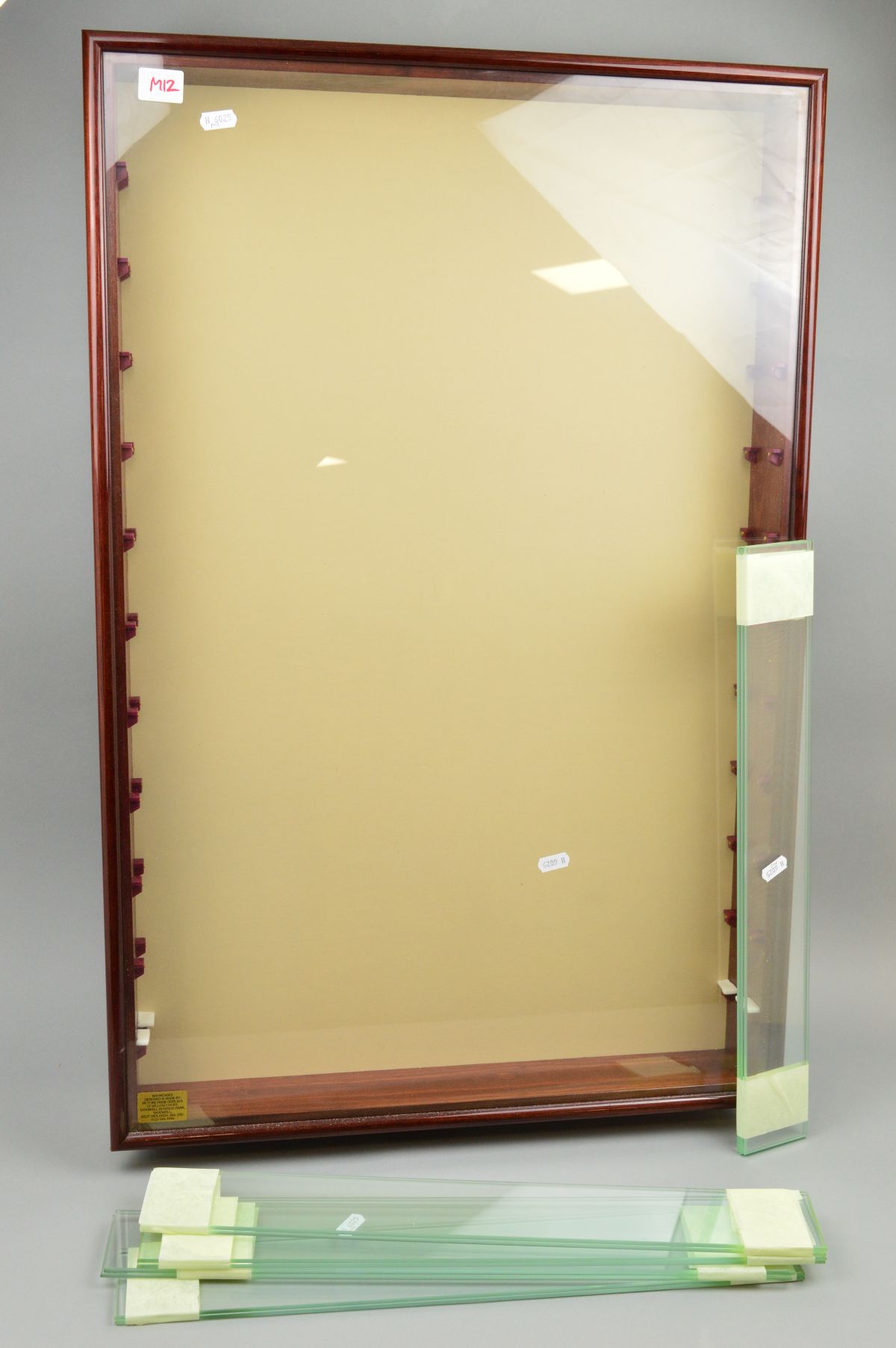 A GLASS FRONTED WALL MOUNTED WOODEN DISPLAY CABINET, approximate size 84cm high x 55cm wide x 9cm