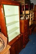 A REPRODUCTION MAHOGANY OPEN BOOKCASE, with a painted interior above a double cupboard door base and