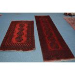 A BOKARA CARPET RUNNER, red and black ground, 280cm x 82cm, together with a similar rug, 187cm x