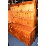 A PINE DRESSER with three drawers and a pine chest of three drawers (2)