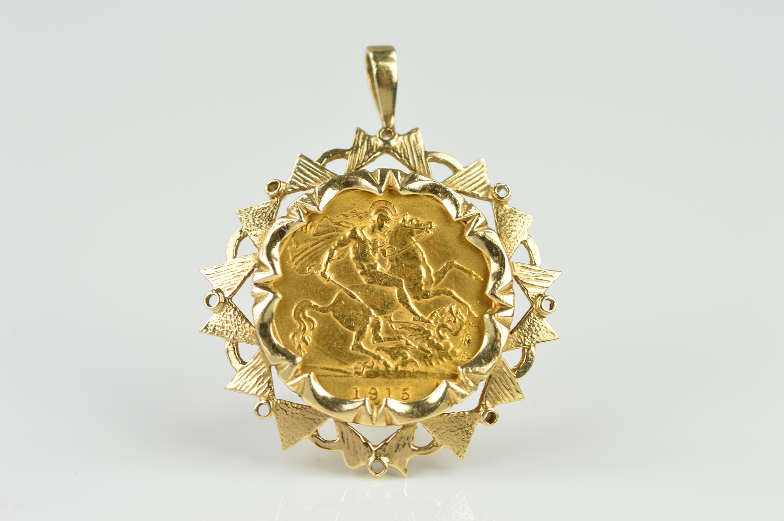 A GEORGE V HALF SOVEREIGN dated 1915, mounted on a later 9ct gold pendant, hallmarked 9ct gold