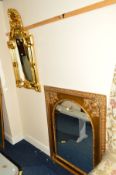 A MODERN FOLIATE GILT FRAMED WALL MIRROR, together with another gilt wall mirrors 87cm x 118cm and