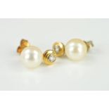 A PAIR OF CULTURED PEARL AND DIAMOND EARRING STUDS, each designed as a cultured pearl with a