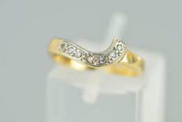 A 9CT GOLD DIAMOND RING, the shaped band set with seven single cut diamonds, 9ct hallmark for