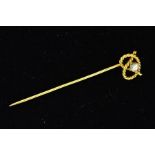 AN 18CT GOLD DIAMOND STICKPIN designed as a rope twist knot set with a central brilliant cut diamond