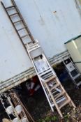 A COLLECTION OF WOODEN LADDERS, comprising of a set of double extension ladders, two medium