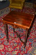 A VICTORIAN ROSEWOOD OCCASIONAL TABLE, raised on four barley twist supports united by a shaped cross
