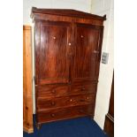 A GEORGIAN MAHOGANY LINEN PRESS, the double panelled door revealing four long slides above two