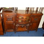 AN EDWARDIAN OAK BOW FRONT SIDEBOARD with three central drawers (missing back) width 151cm x depth