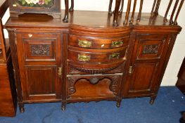 AN EDWARDIAN OAK BOW FRONT SIDEBOARD with three central drawers (missing back) width 151cm x depth