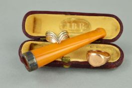 AN EARLY 20TH CENTURY NATURAL AMBER CHEROOT AND TWO RINGS, the cheroot with silver mount and