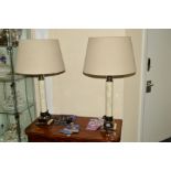 A PAIR OF MODERN CHROME FRAMED CYLINDRICAL TABLE LAMPS, with oatmeal coloured shades