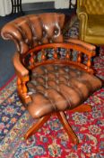 A MAHOGANY FRAMED BROWN LEATHER SWIVEL OFFICE CHAIR