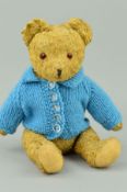 A GOLDEN WOOL PLUSH TEDDY BEAR, glass eyes, vertical stitched nose, jointed arms and legs,