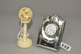 A CARR'S SILVER MOUNTED EASEL BACK BEDSIDE TIME PIECE, Edwardian style ribbon and swag embossed