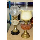 TWO BRASS OIL LAMPS, both with glass wells, funnels and shades, height tallest base 34cm (2)