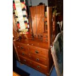 AN EDWARDIAN PITCH PINE DRESSING TABLE with a triple mirror and eight various drawers, width 105cm