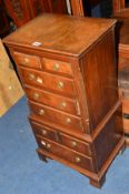 A SMALL REPRODUCTION GEORGIAN STYLE MAHOGANY AND BANDED CHEST ON CHEST of eight various drawers,