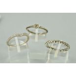 THREE PANDORA RINGS to include a v-shaped half eternity ring, a heart shape colourless gem with