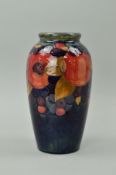 A MOORCROFT POTTERY VASE, 'Pomegranate' pattern on a blue ground, impressed mark and painted