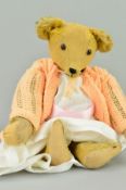 A WELL LOVED GOLDEN PLUSH TEDDY BEAR, earlier bear with long snout, longer curved arms and a hump to