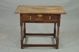 A GEORGIAN OAK LOWBOY, the rectangular top above a single long drawer, on turned supports united