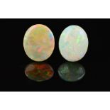 TWO OPAL OVAL CABOCHON CUT STONES, one measuring 20mm x 17mm, one measuring 20mm x 17mm, total