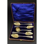 A CASED HARLEQUIN SET OF FOUR GEORGIAN SILVER BERRY SPOONS AND CASTER SPOON, gilt bowls embossed