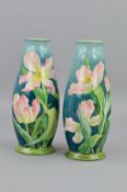 A PAIR OF DOULTON LAMBETH FAIENCE VASES, being of baluster form with Iris flower decoration,
